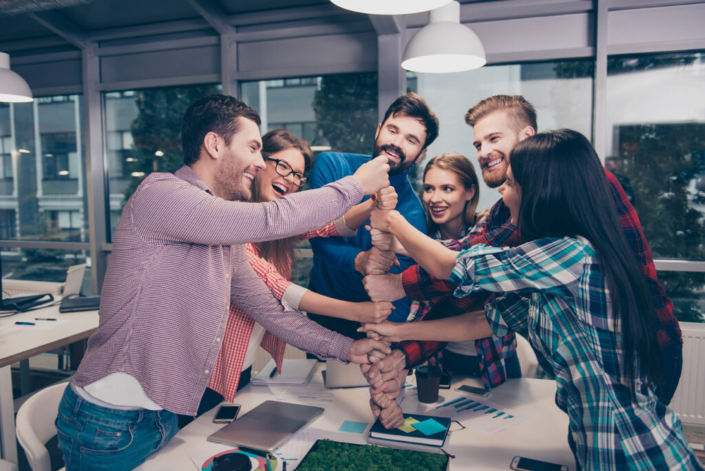 happy,businesspeople,putting,their,fist,on,top,of,each,other